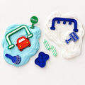 Happy Hands Party Co car wash play dough accessories set with red car, blue tool, brush, wash and rinse signs, and green striped rollers.